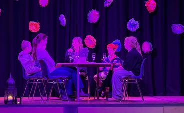 en gruppe mennesker som sitter ved et bord med en mikrofon